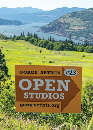 A sign advertising Gorge Artists Open Studios, numbered 23, Mark Nilsson, Gorge Artist with a scenic landscape of hills, a river, and green fields in the background. Mark Nilsson ©
