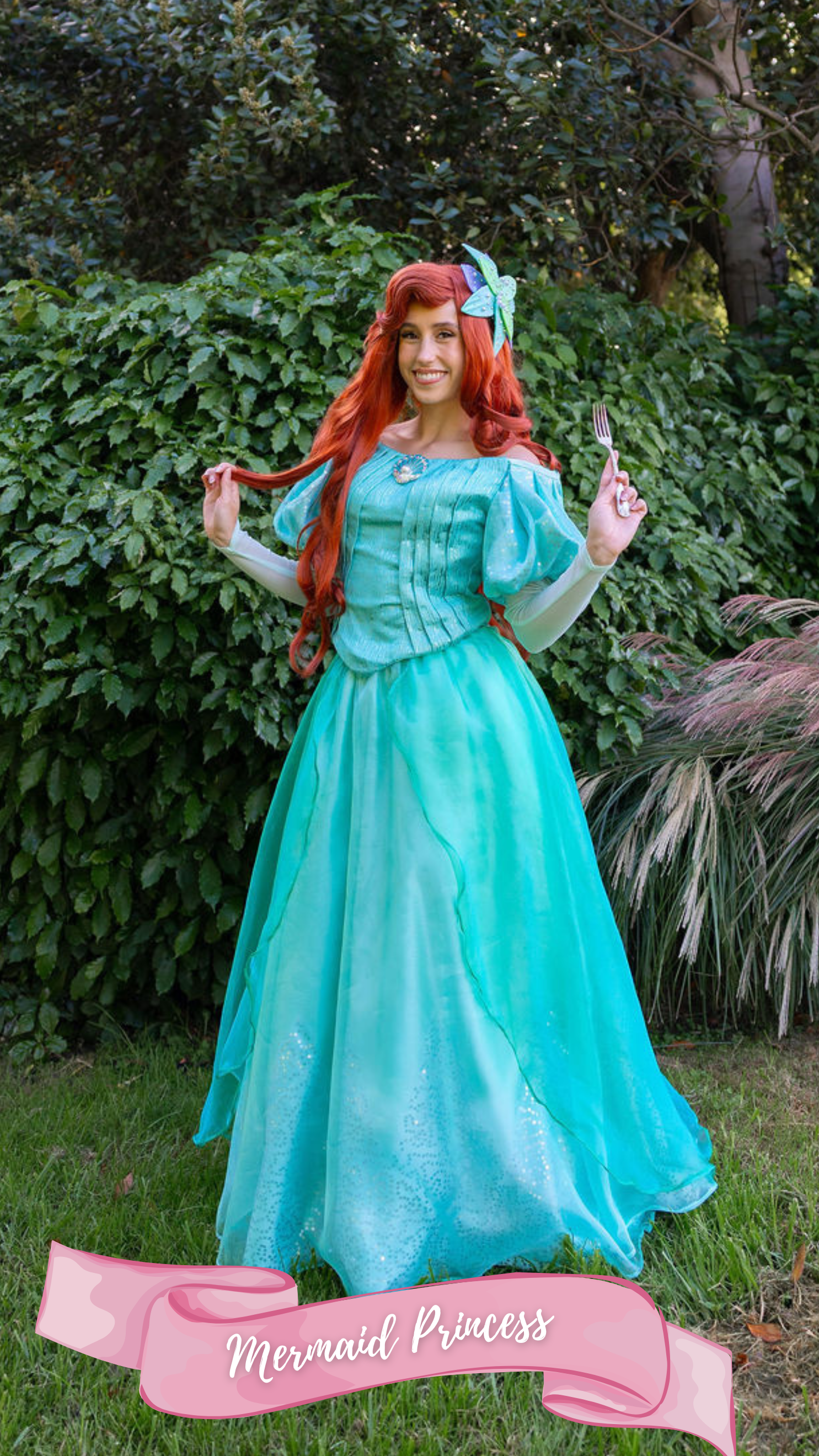 A woman dressed as a mermaid princess with red hair, wearing a shiny turquoise gown with puffed sleeves, standing outdoors near a brick wall and greenery, with a pink banner at the bottom that says 'Mermaid Princess'.