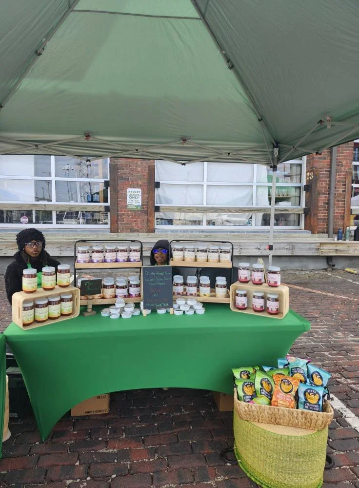 Efinity Harvest Farm market booth in Trotwood, Ohio displaying jars of fresh, locally made products and value added goods promoting food access and community agriculture