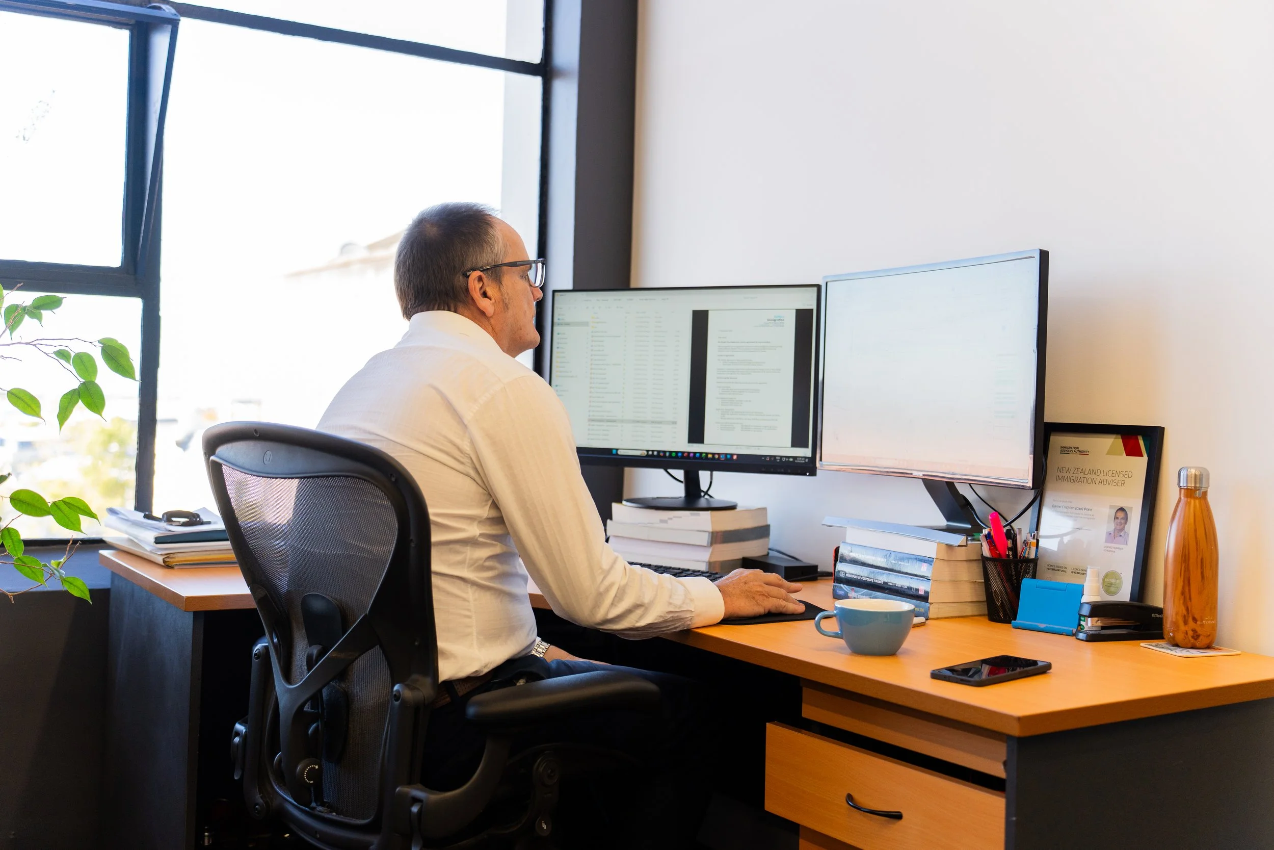 Dan Prain working at Settlers Immigration Dunedin office
