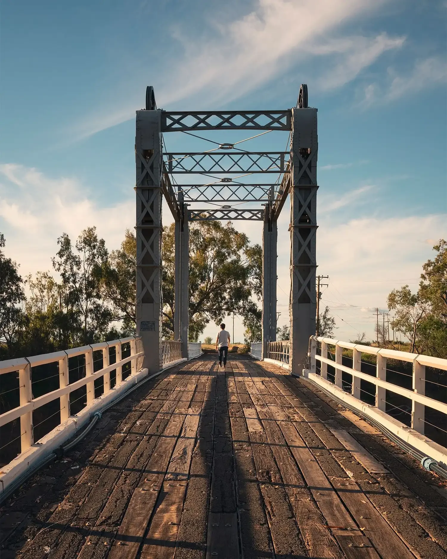 Historic Barwon bridge with person standing in the centre. Mandatory image credit: Destination NSW