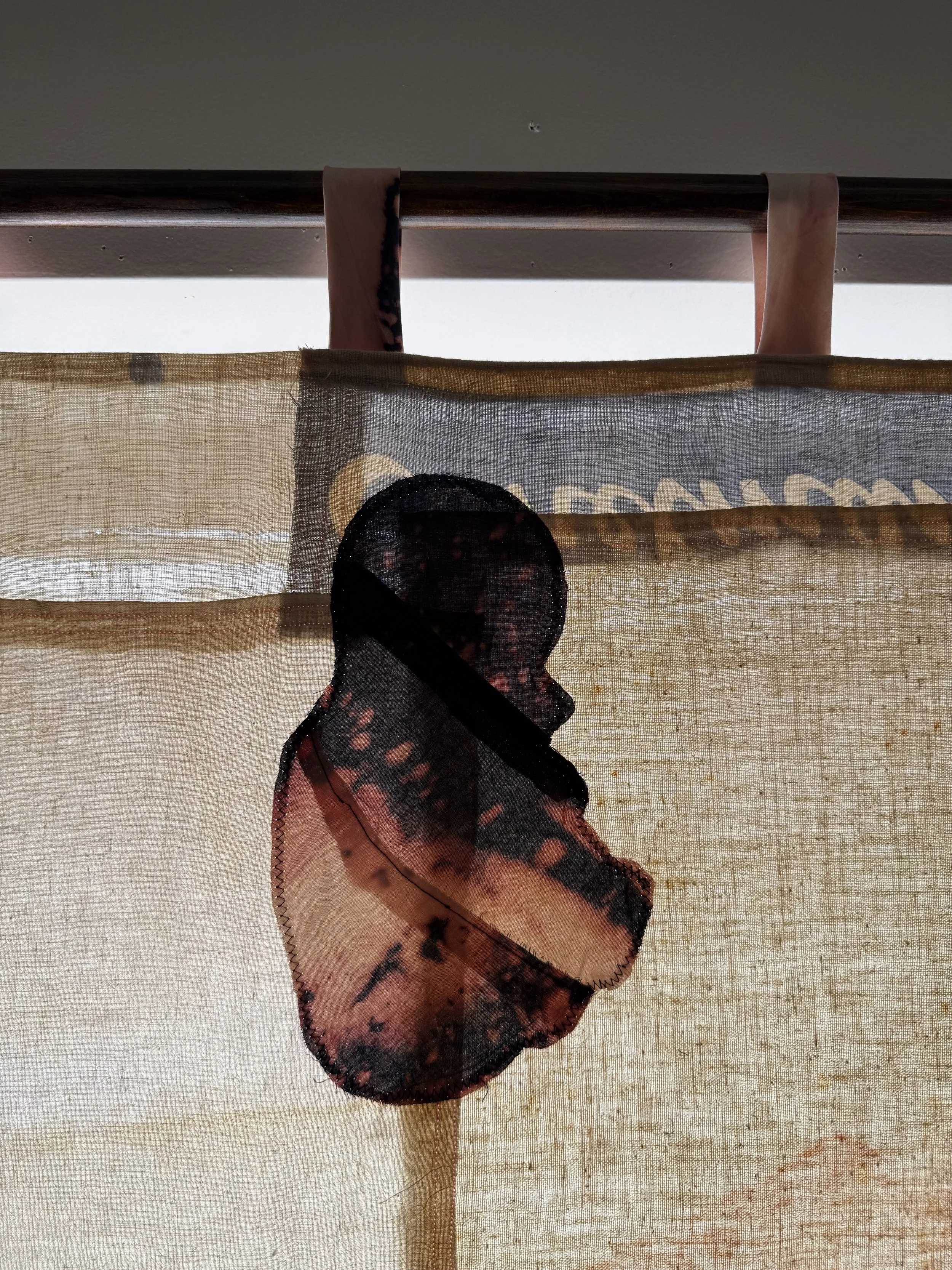 "Cecilia" (2026) (detail, in evening light) 70" x 57" Bleached bedsheets, coffee, fluid watercolor, relief prints, used feed, seed and soap sacks, hand embroidery
