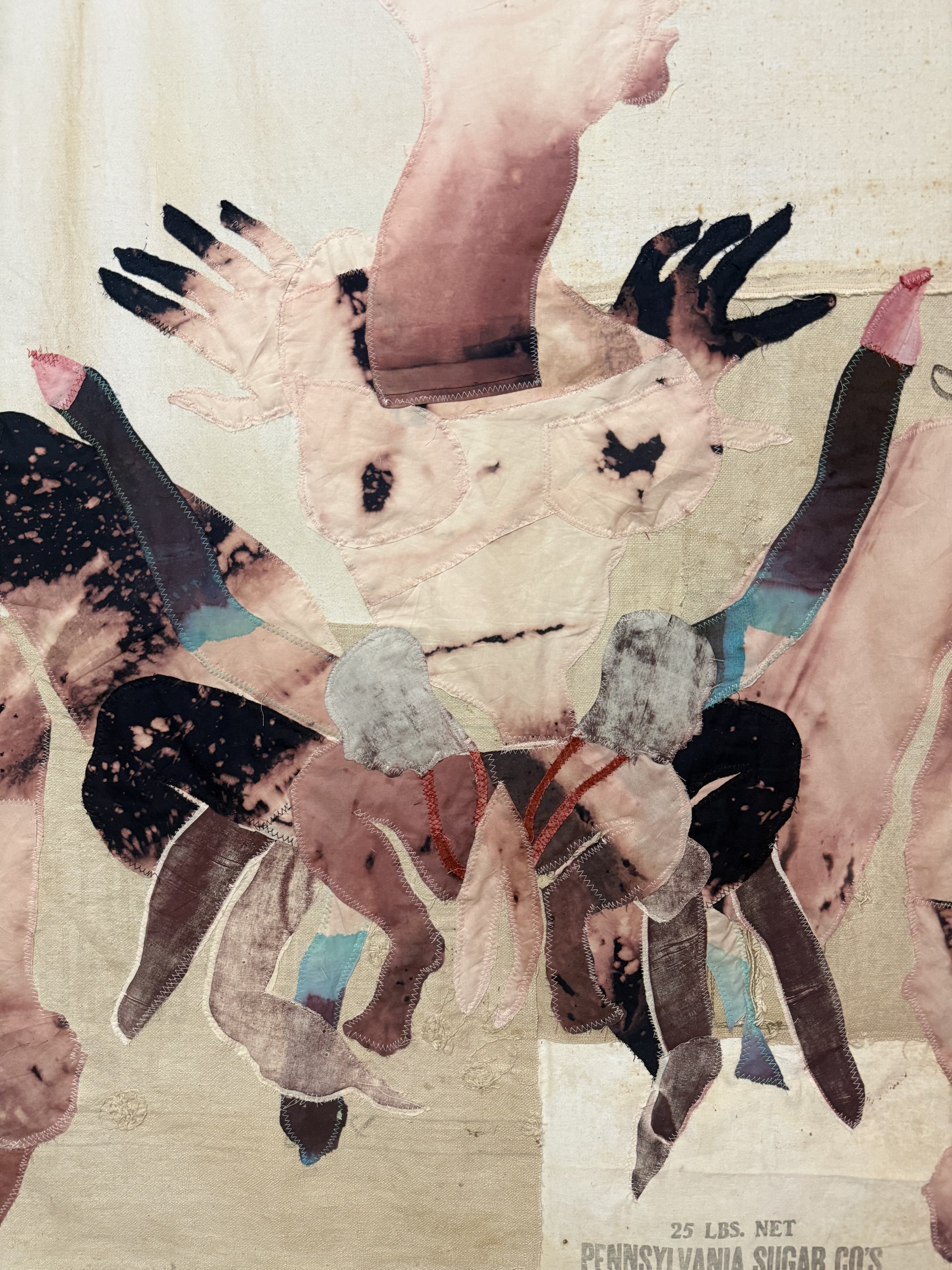 "Cecilia" (2026) (detail, no backlighting) 70" x 57" Bleached bedsheets, coffee, fluid watercolor, relief prints, used feed, seed and soap sacks, hand embroidery