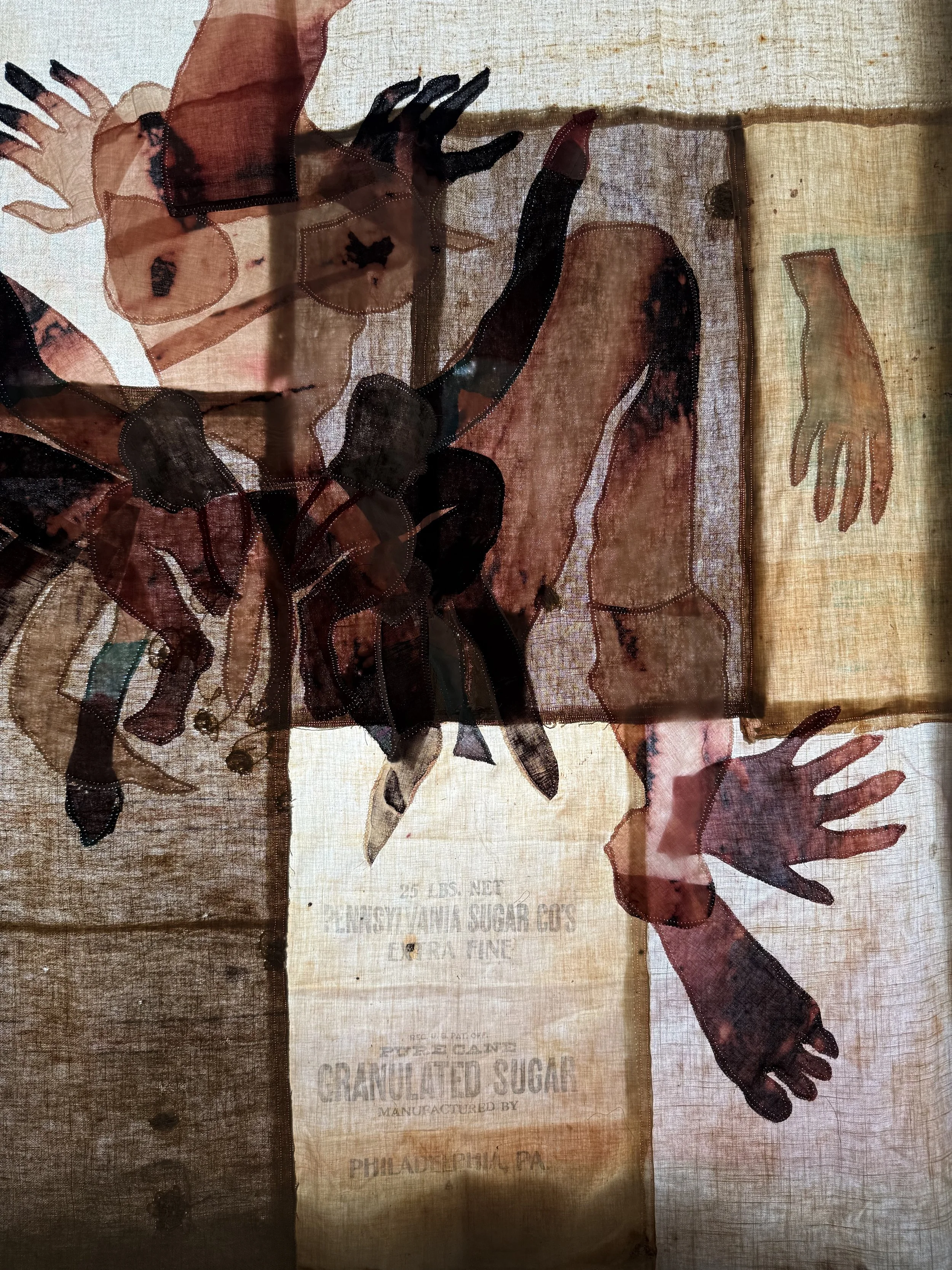 "Cecilia" (2026) (detail, in evening light) 70" x 57" Bleached bedsheets, coffee, fluid watercolor, relief prints, used feed, seed and soap sacks, hand embroidery