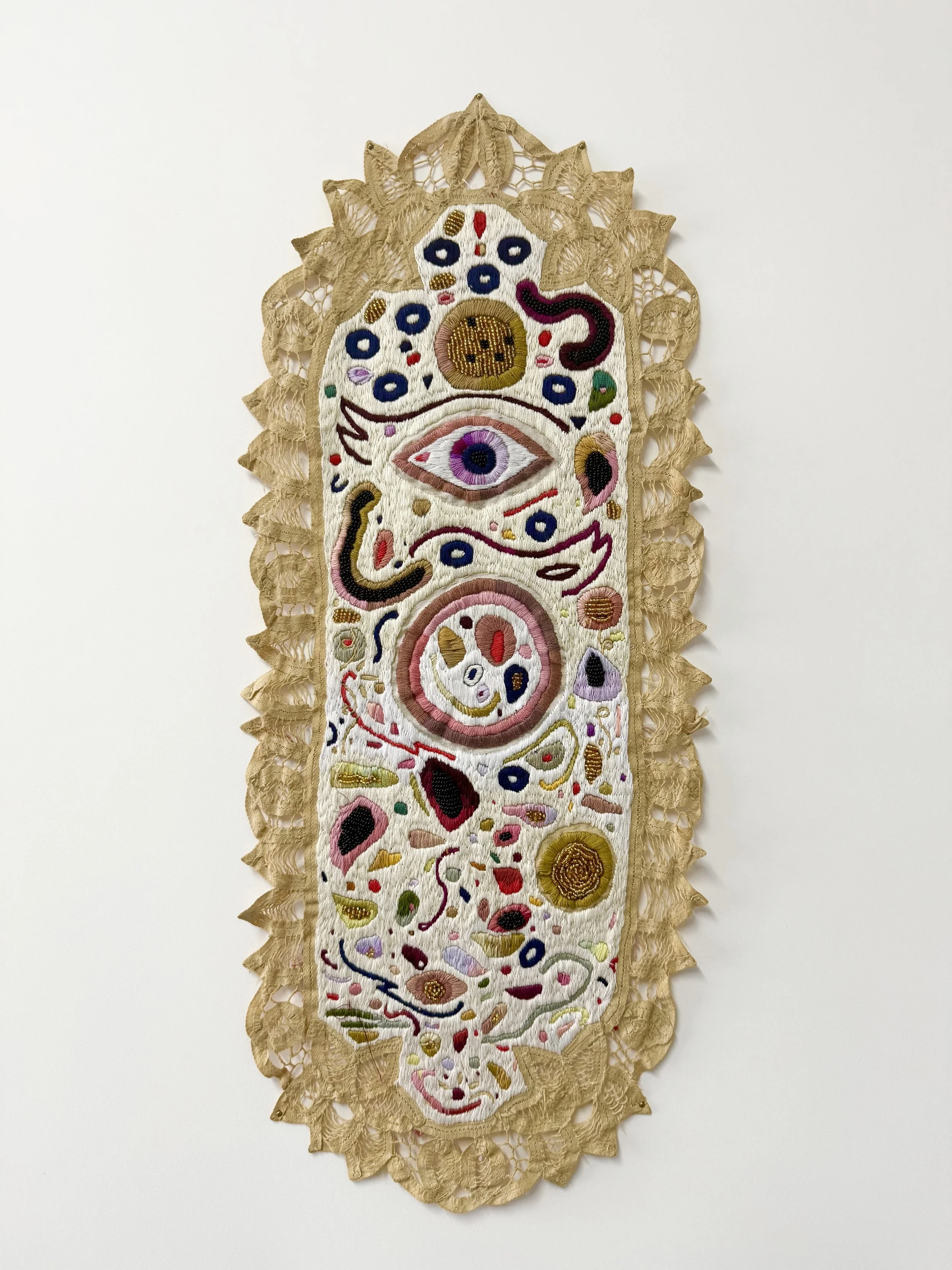"Portal" 20" x 10" (2023) hand embroidery and beading on antique cotton table runner dyed with pomegranate skins $5,000