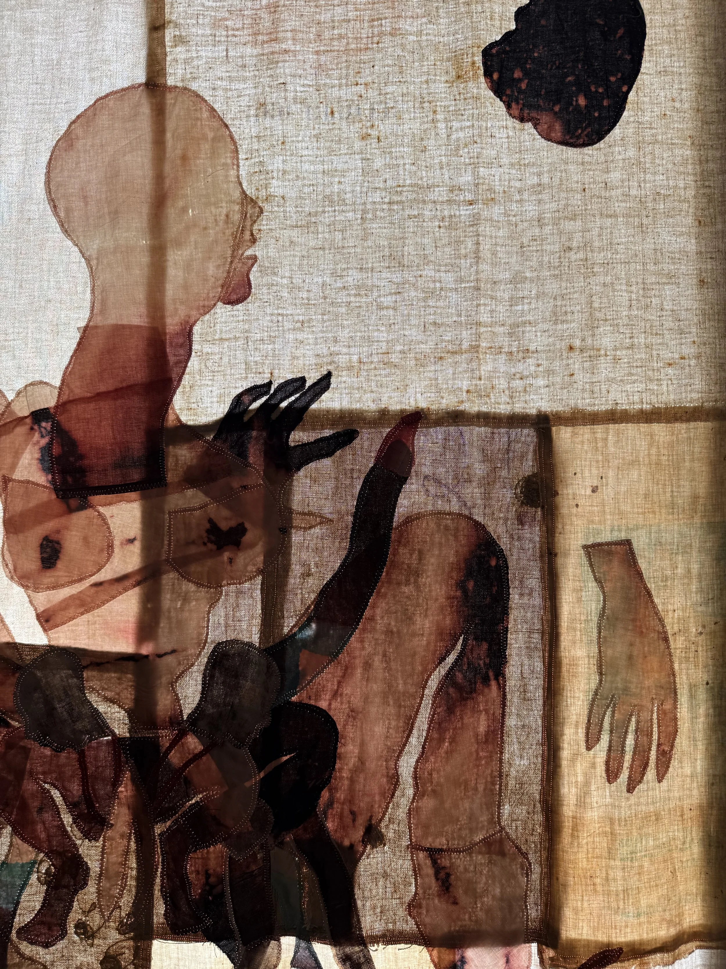 "Cecilia" (2026) (detail, in evening light) 70" x 57" Bleached bedsheets, coffee, fluid watercolor, relief prints, used feed, seed and soap sacks, hand embroidery