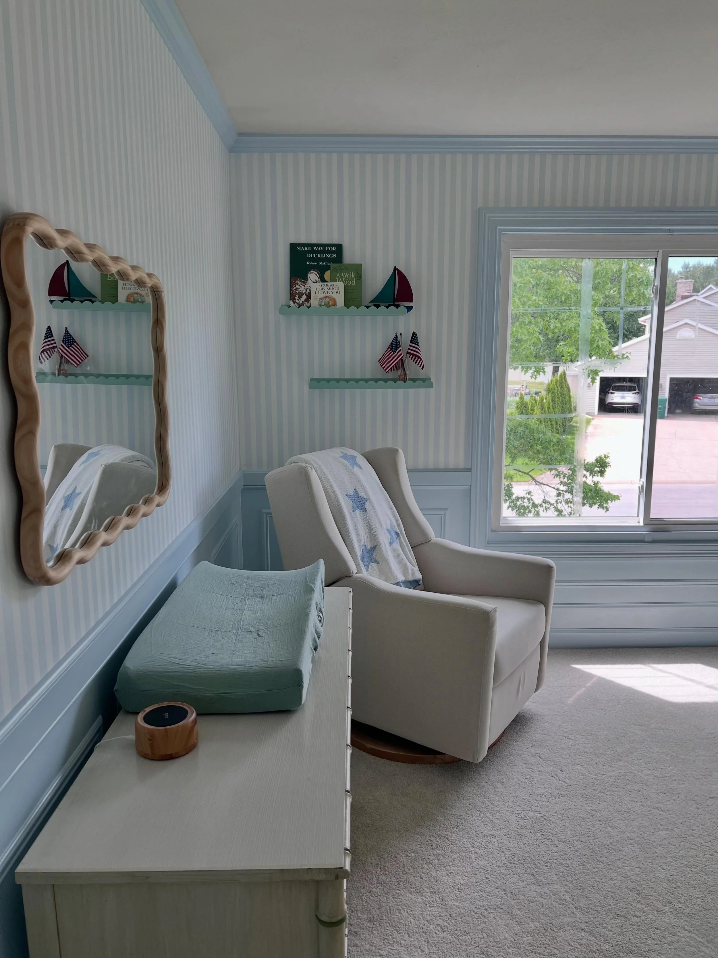 Classic stripes and cozy corners! This wallpaper was the perfect touch for this nursery!