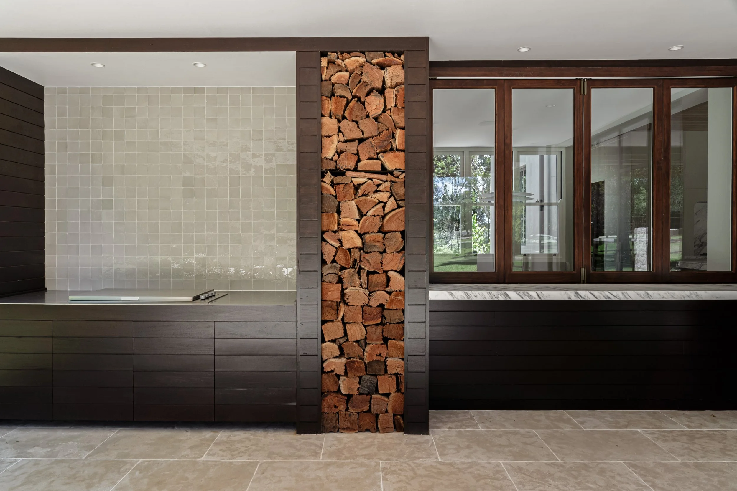 Custom BBQ joinery with integrated wood storage in a Southern Highlands home