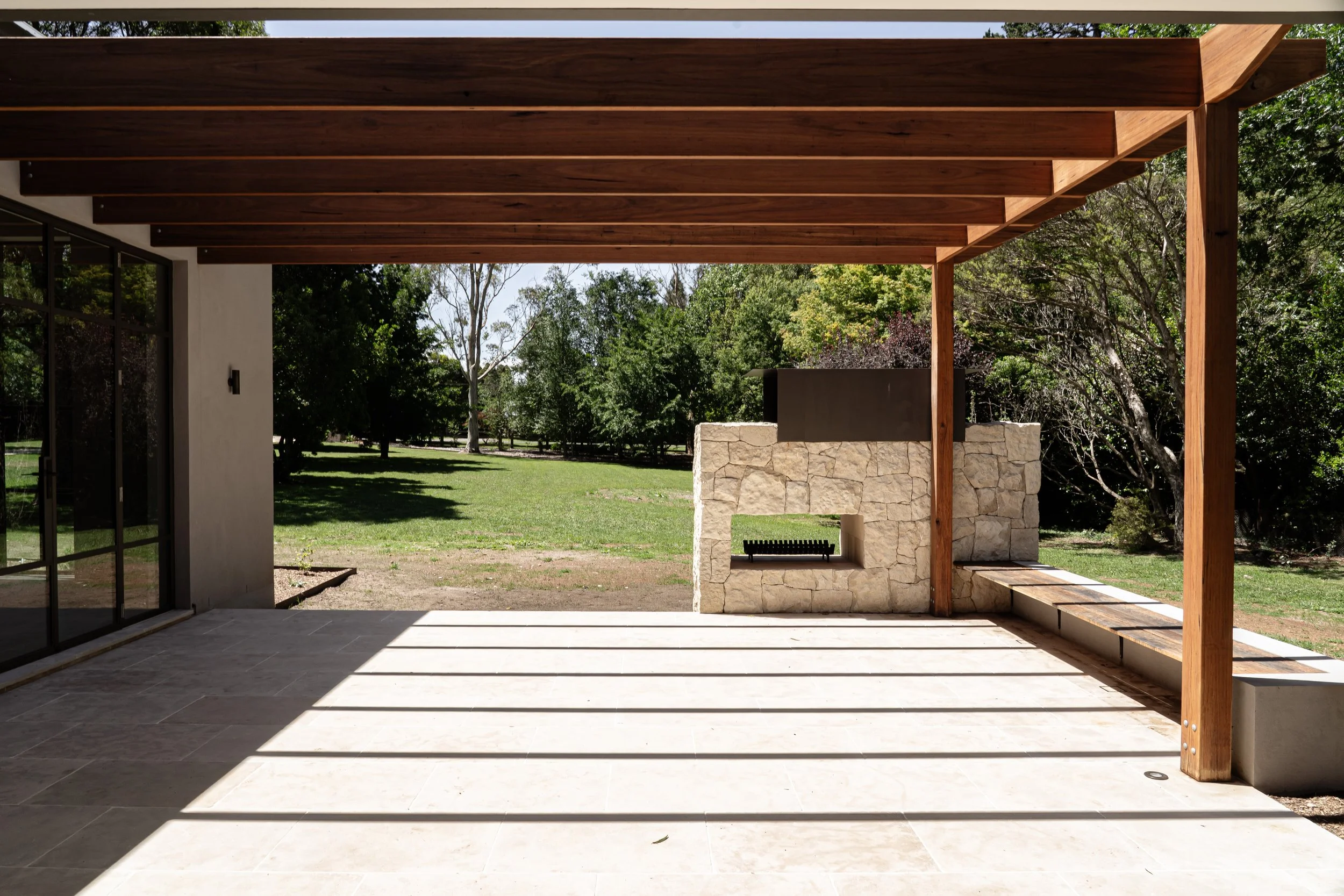 Outdoor entertaining area with timber pergola in a Southern Highlands home