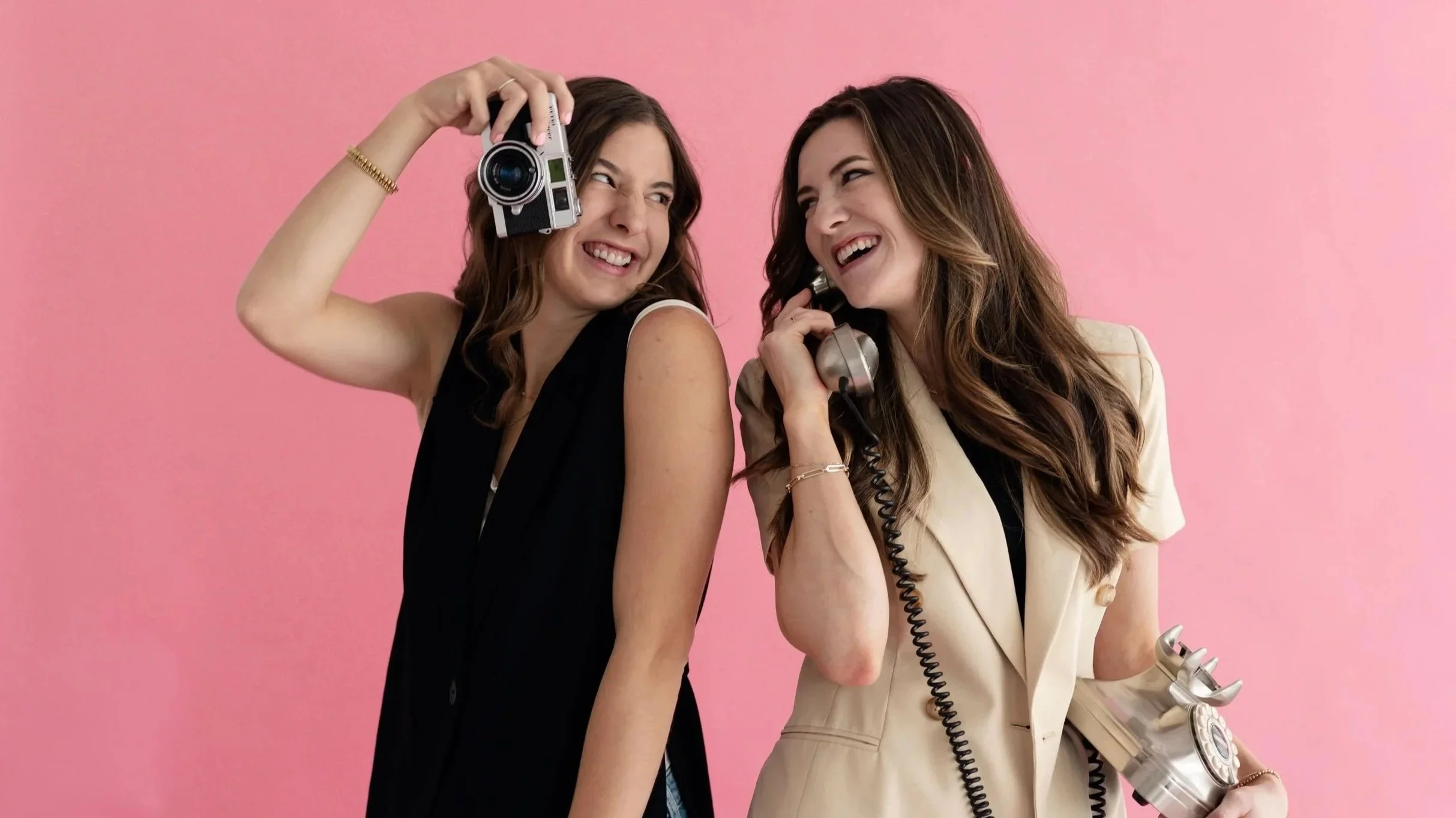 Marketing professionals holding camera and phone