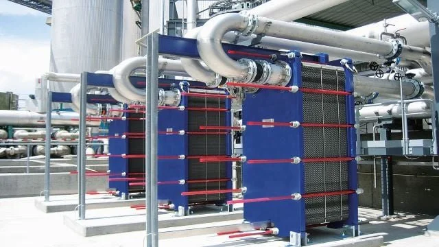 Industrial cooling system with large blue heat exchangers and silver piping.