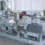 Retail store display of kitchen appliances and cookware, including blenders, toasters, and pots.