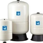 Three white water softener tanks with blue logos on a white background