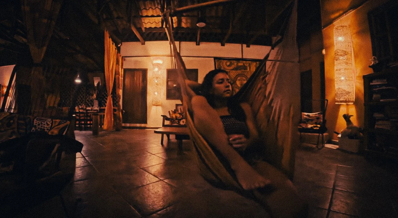Guest relaxing in a hammock at Casa Moabi in Playa Chiquita, Costa Rica, a jungle accommodation near Puerto Viejo with a warm wooden interior.