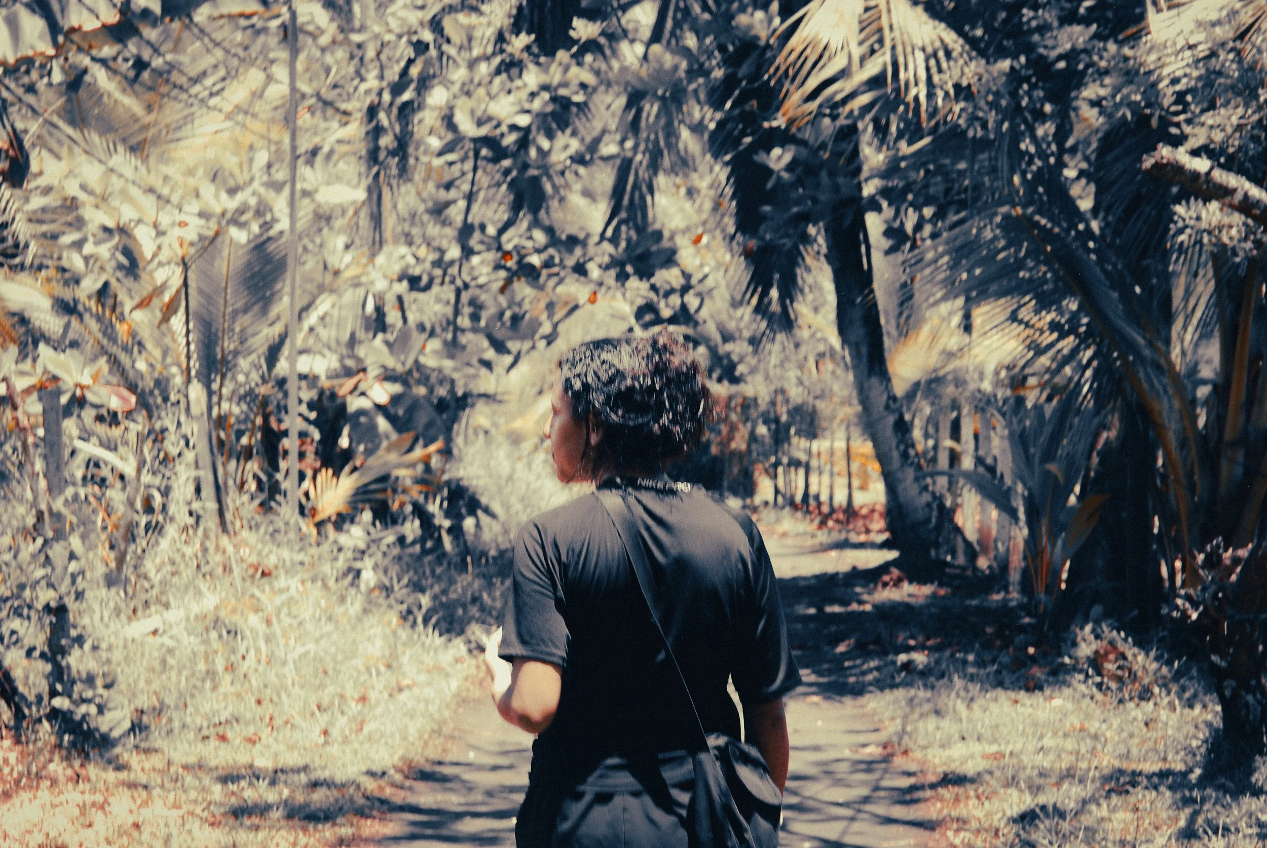Solo female traveller walking through a jungle path in Parismina, Costa Rica