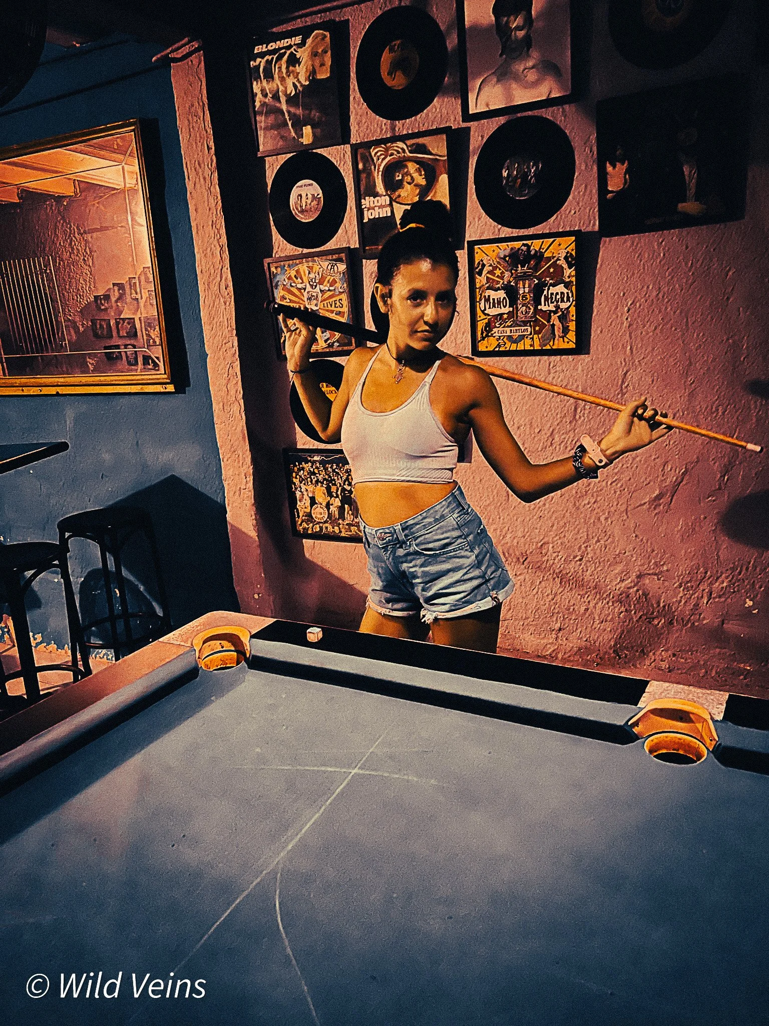 Old photo of me inside a colourful Barcelona bar, playing pool in one of the strange hidden bars I found while growing up around the city.