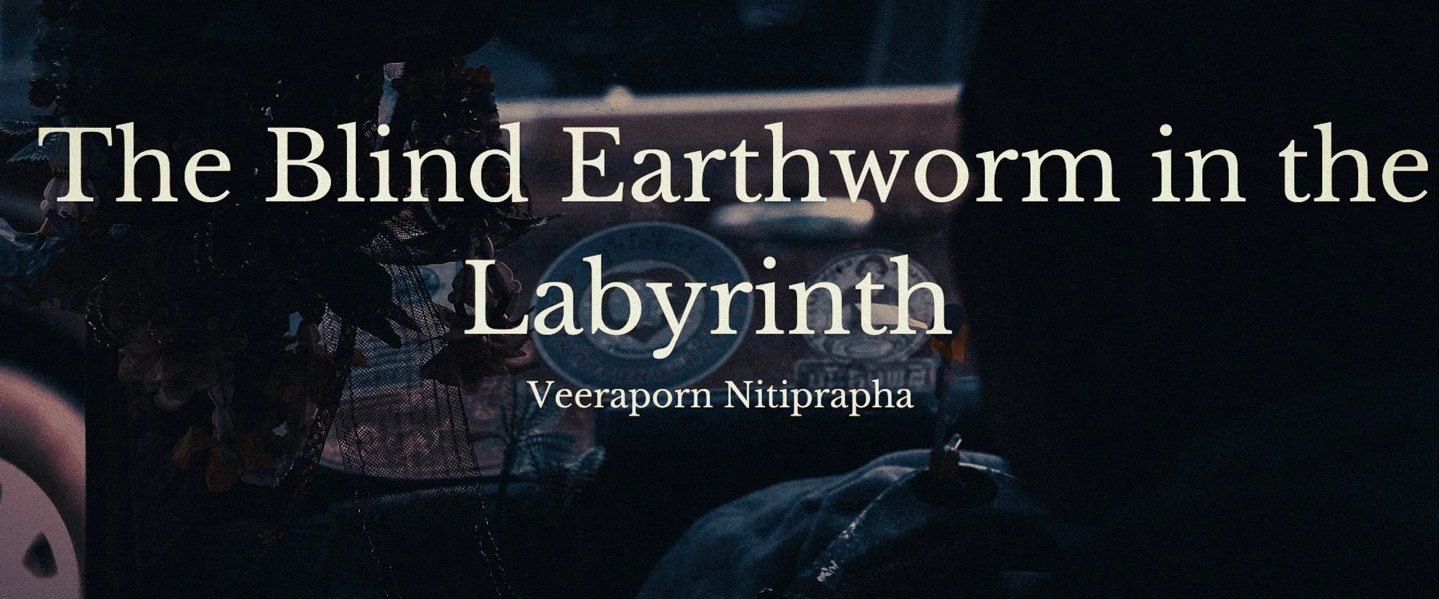 Dark literary banner for The Blind Earthworm in the Labyrinth by Veeraporn Nitiprapha, with a moody rainy blue-toned background.