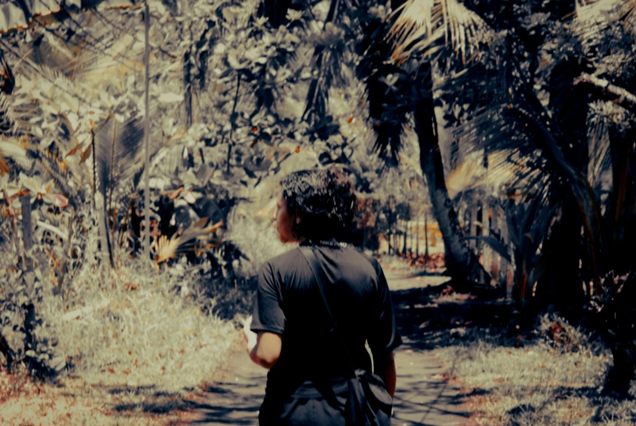 woman walking though a jungle village in Costa Rica