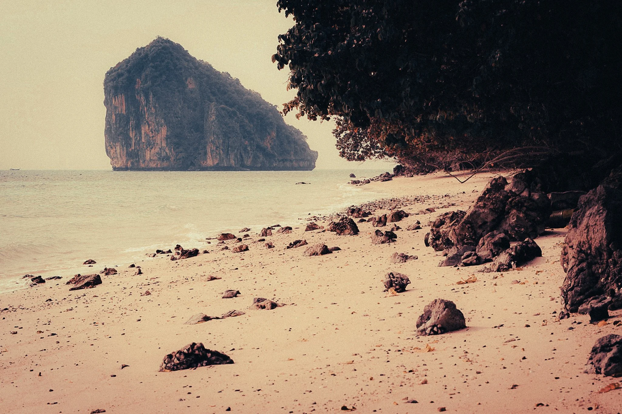 Quiet beach near Phuket with limestone cliffs offshore, a peaceful alternative to Maya Bay in Thailand.