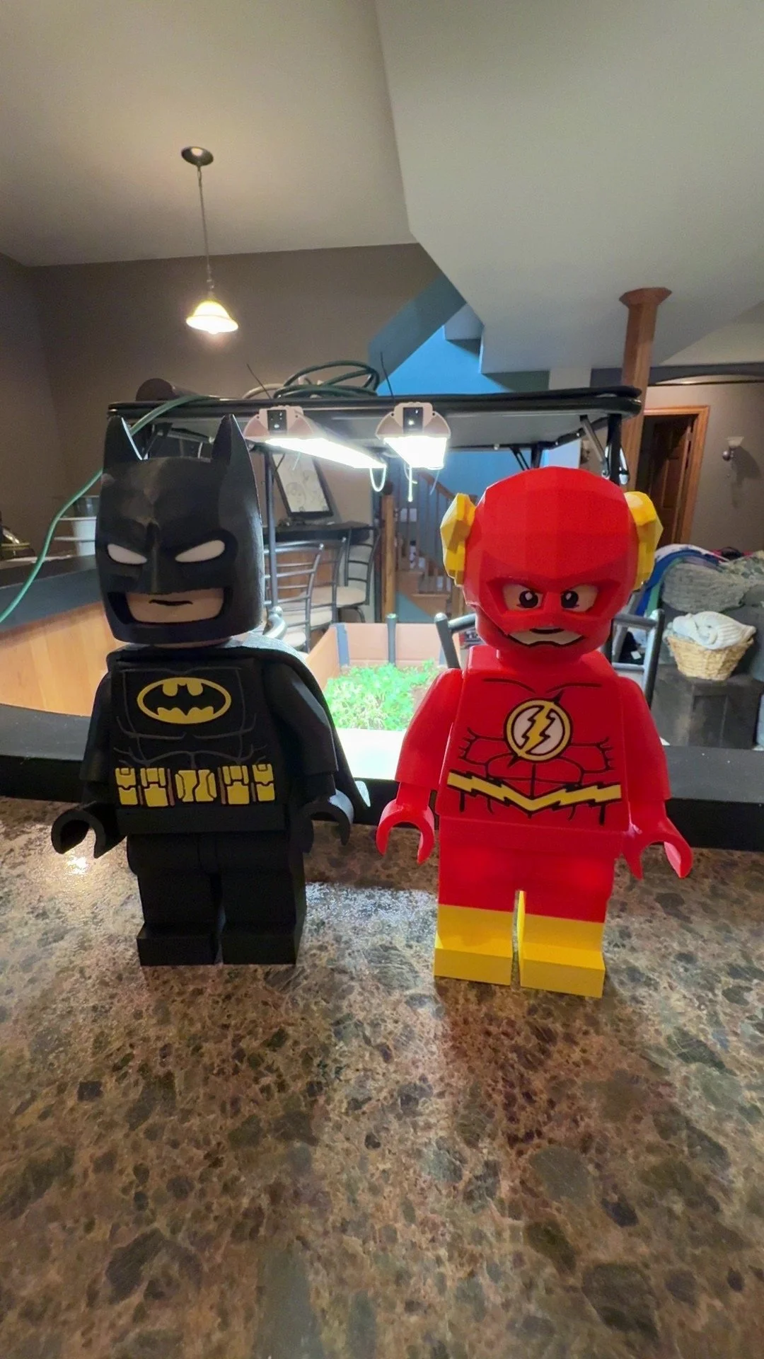 LEGO figurines of Batman and The Flash on a kitchen counter.