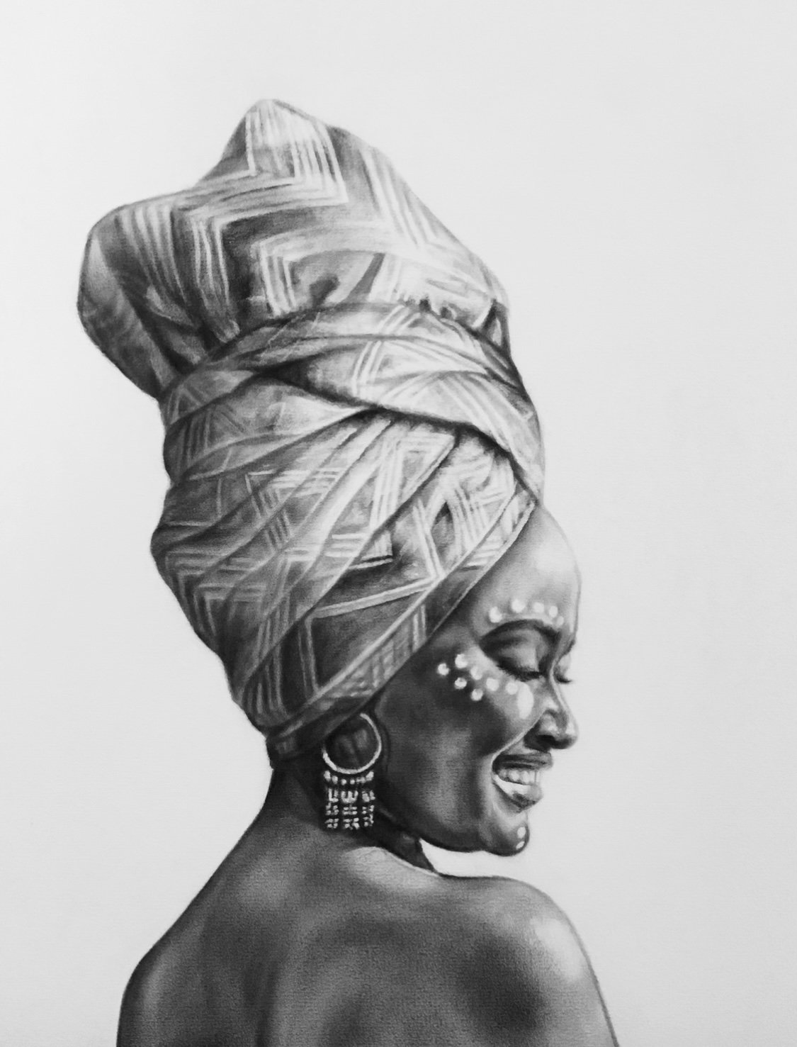 A black and white lifelike drawing of a smiling woman wearing a traditional head wrap with geometric patterns, large earrings, and decorative facial adornments, facing sideways.