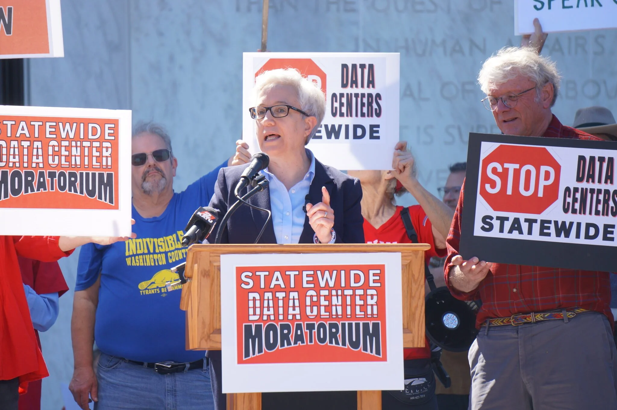 Gov. Tina Kotek at a rally on Tuesday, September 8, 2026 on the steps of the Oregon State Capitol with citizens with signs around her saying stop data centers statewide
