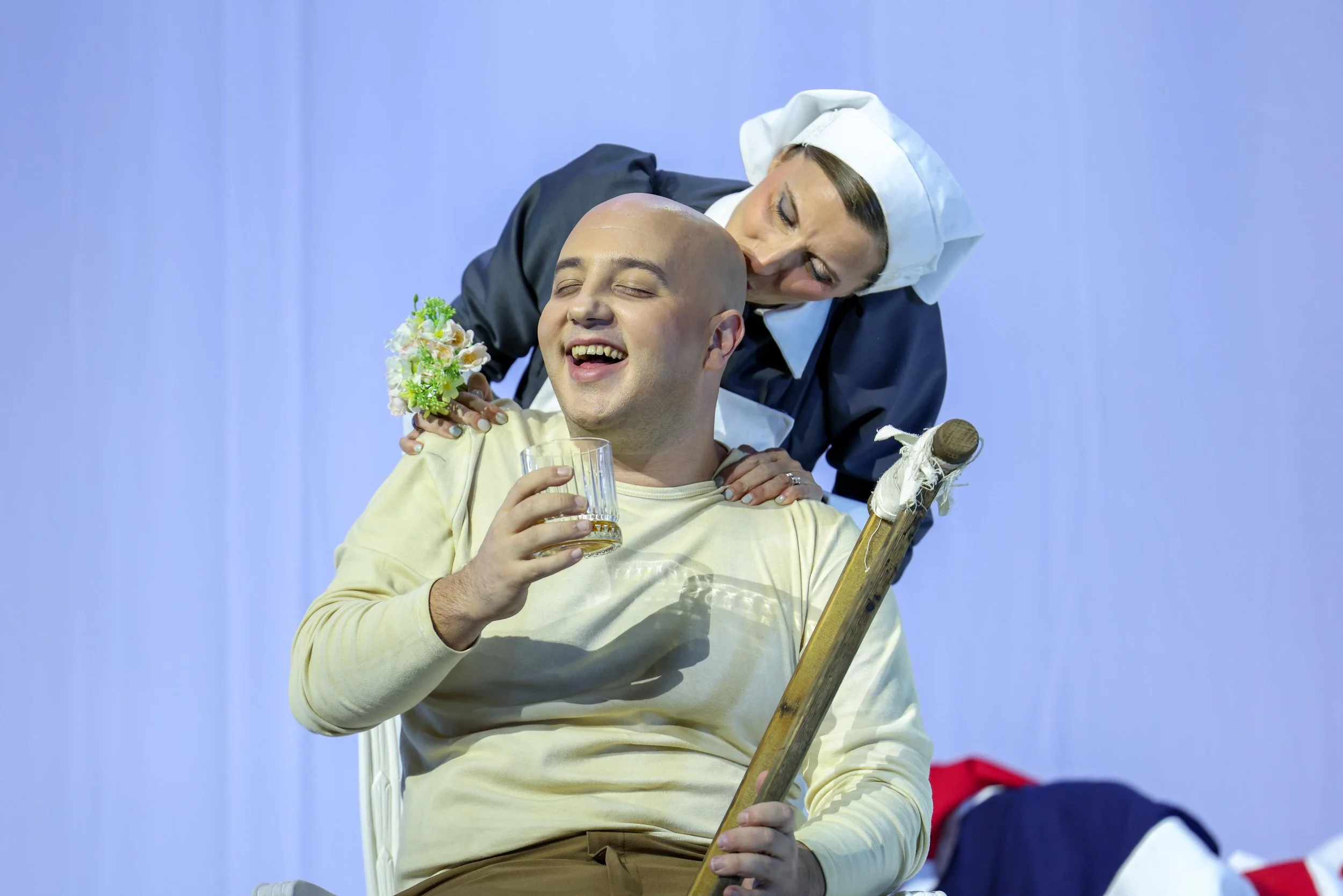 Scene from Gluck’s La corona at the Valletta Baroque Festival, directed by Brett Nicholas Brown, featuring a nurse attending to a seated solider in a 1940s wartime setting