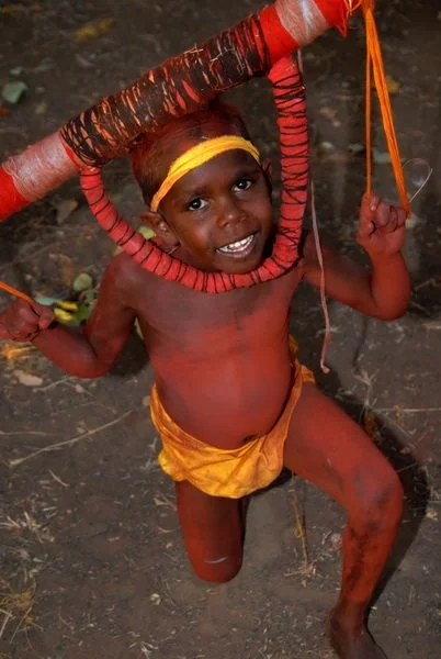 Young painted dancer in yellow