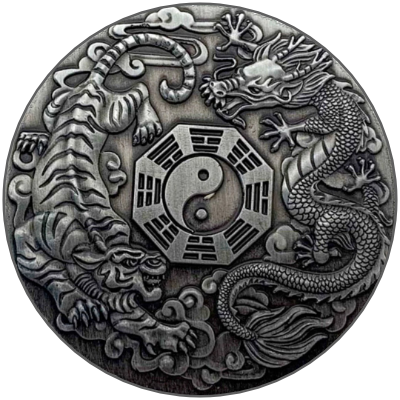 A decorative circular silver medallion featuring a yin-yang symbol surrounded by a dragon and a tiger.