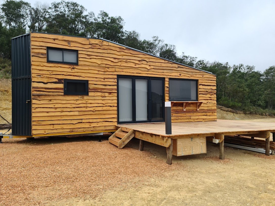 The 50 square meter deck adds tons of living space to the tiny house, complete with dimmable outdoor light and wood store. 
A 5kw inverter with lithium batteries, charged by the solar covered roof of the CaveLet keeps the lights on.