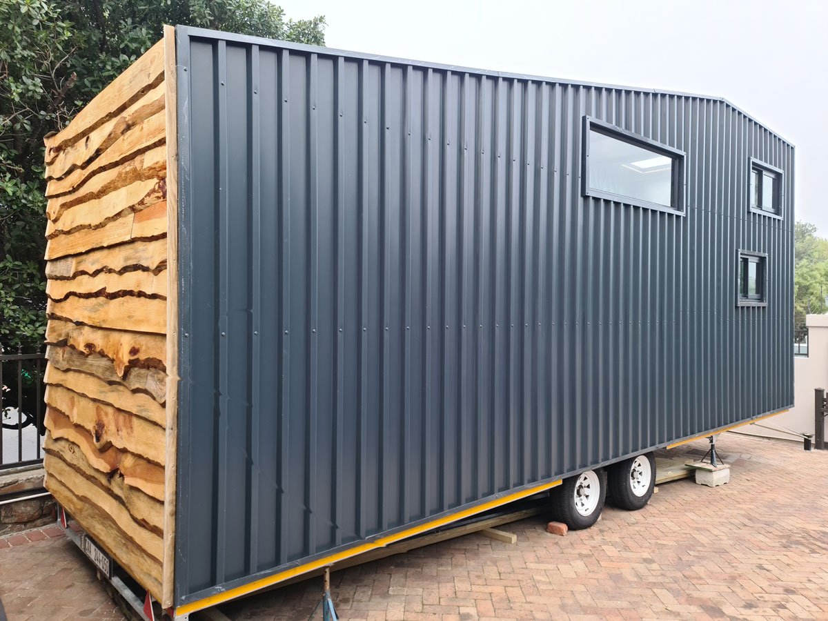 Locally sourced pine creates a beautiful live edge lap-board finish while the rear of the CaveLet tiny house is cladded in coloured IBR sheets.