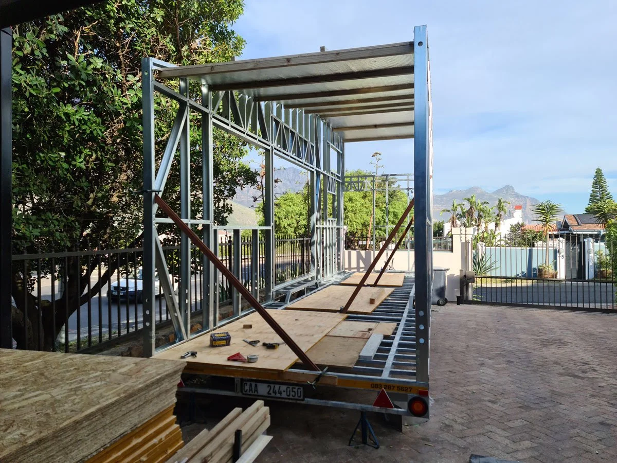 Light steel frame construction is used to keep the tiny house weight to a minimum on the professionally built double axle trailer.