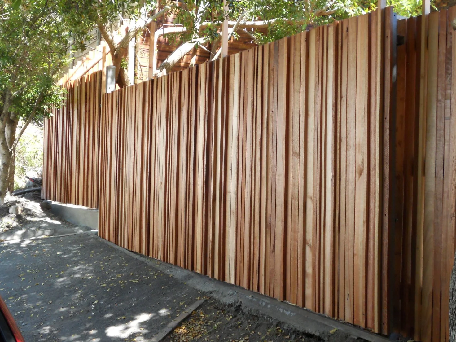 Red gum timber cut to various sizes and arranged to create this effect. Inside – solid red gum timber beams and galvanized posts, longevity guaranteed