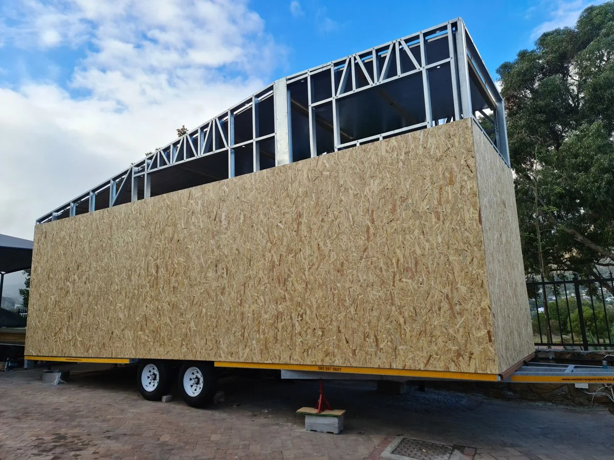 Light steel frame construction is used to keep the tiny house weight to a minimum on the professionally built double axle trailer.