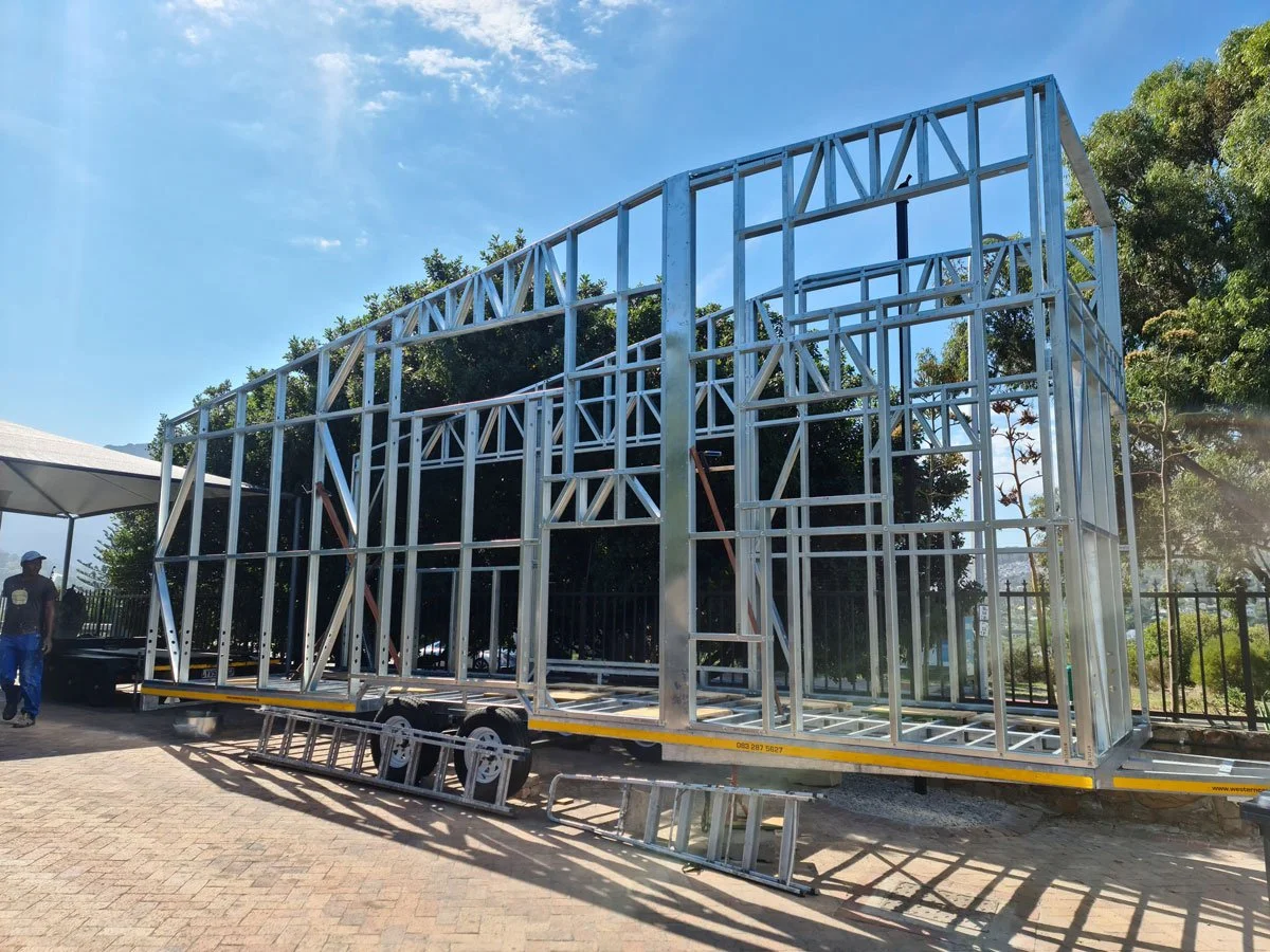 Light steel frame construction is used to keep the tiny house weight to a minimum on the professionally built double axle trailer.