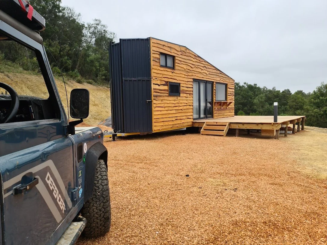 The 50 square meter deck adds tons of living space to the tiny house, complete with dimmable outdoor light and wood store. 
A 5kw inverter with lithium batteries, charged by the solar covered roof of the CaveLet keeps the lights on.