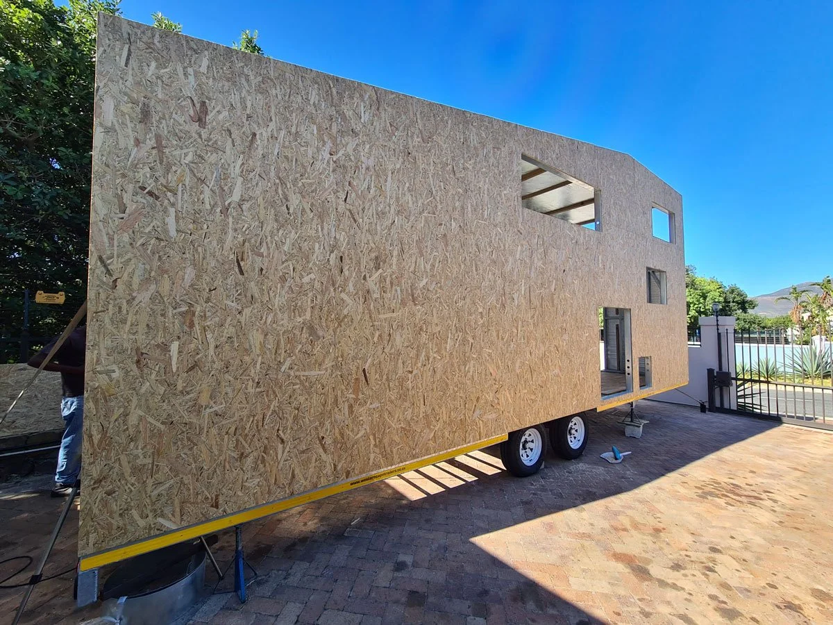 Light steel frame construction is used to keep the tiny house weight to a minimum on the professionally built double axle trailer.