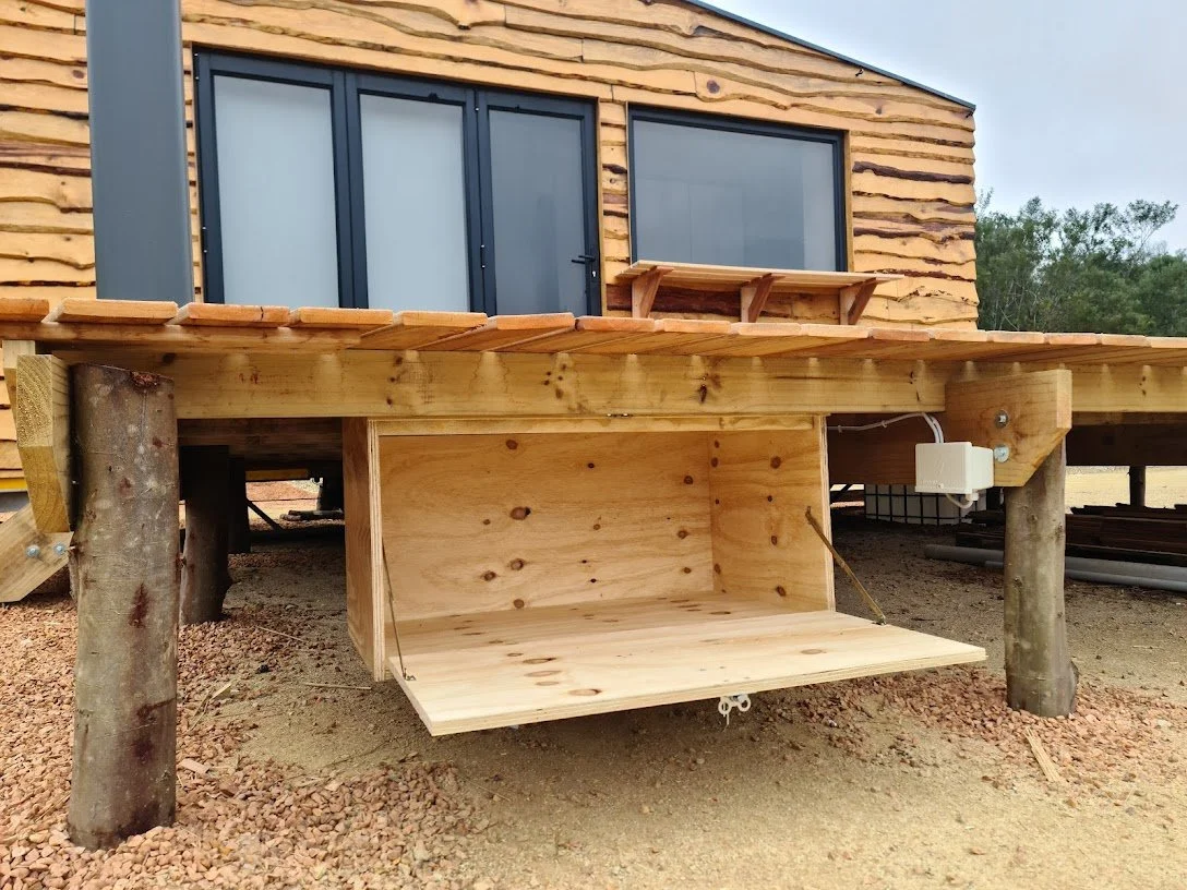The 50 square meter deck adds tons of living space to the tiny house, complete with dimmable outdoor light and wood store. 
A 5kw inverter with lithium batteries, charged by the solar covered roof of the CaveLet keeps the lights on.
