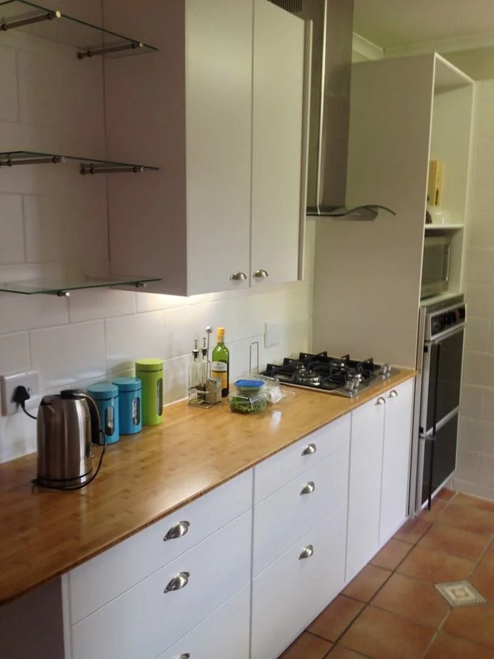 Bamboo worktops and white satin duco'd cupboards refits this kitchen to its former glory.