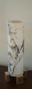 Marbled ceramic vase on small wooden blocks.