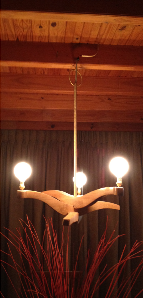 Given the opportunity, one makes a chandelier from parts of a chair. 