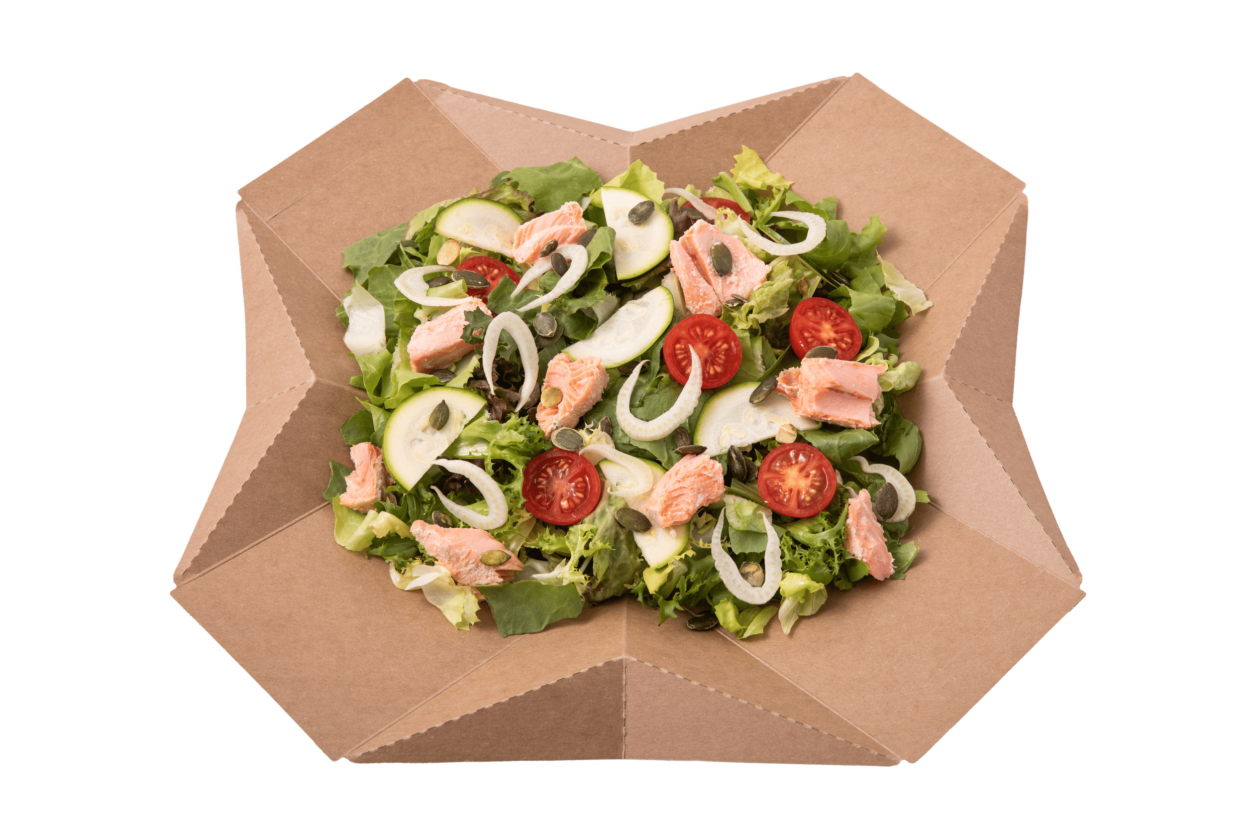Salad with cherry tomatoes, cucumber slices, onion rings, shredded chicken, and pumpkin seeds in a cardboard takeout box.