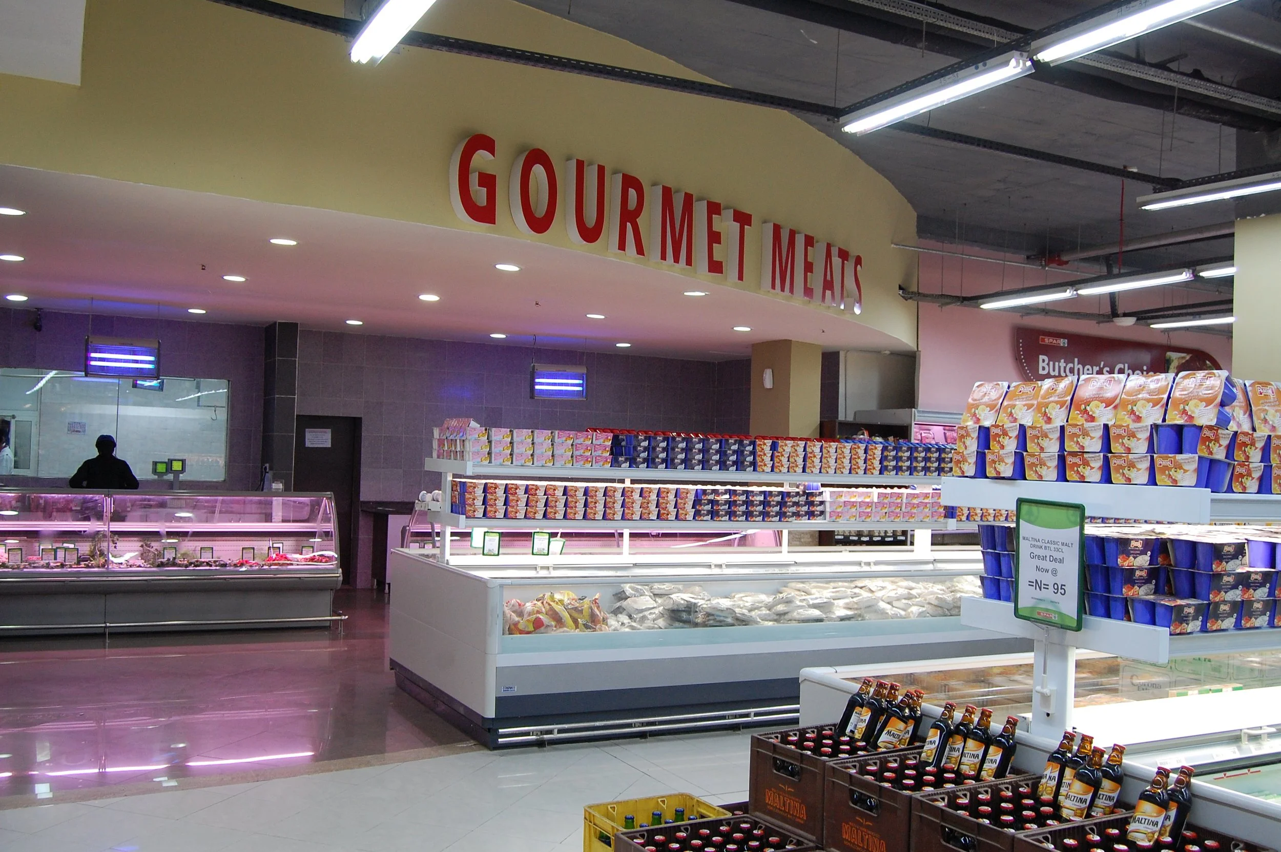 interior supermarket view of butchery and frozen departments