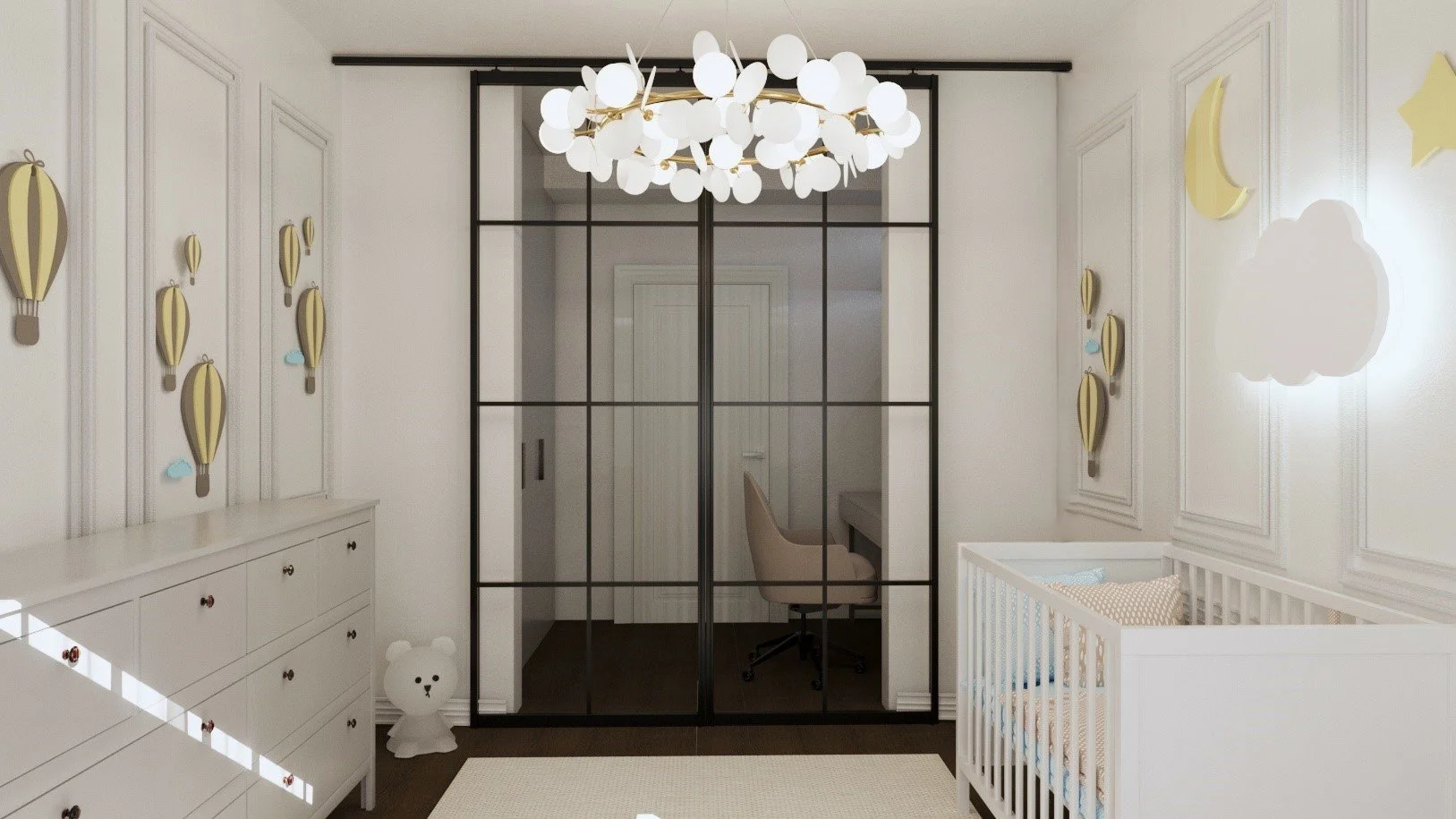 A modern nursery with white walls, decorated with cloud and moon wall art, a white dresser with small colorful handles, a beige teddy bear on the floor, a glass wall with black framing separating the room from a small office nook, and a baby crib wit