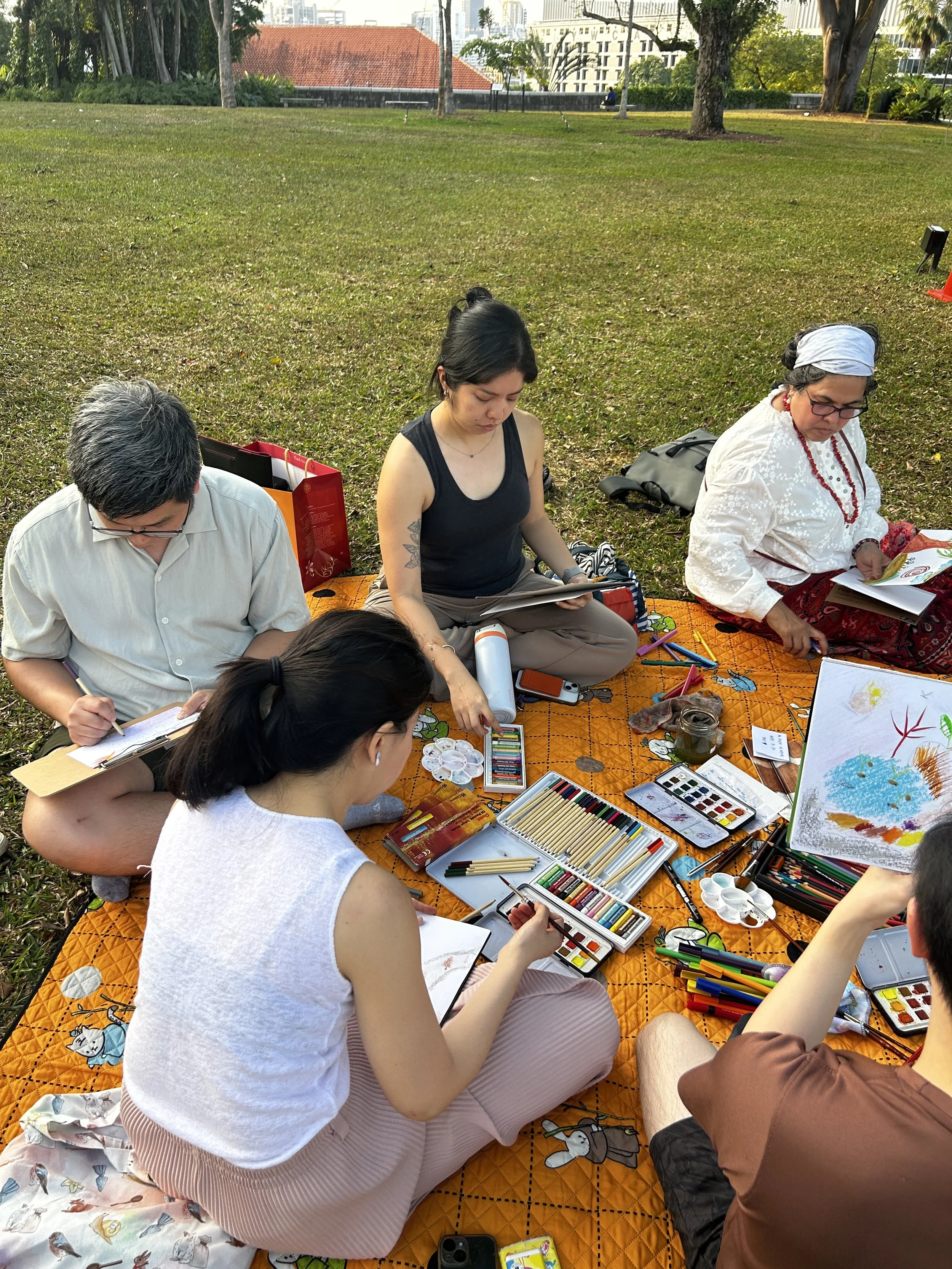Group of people making art in the park