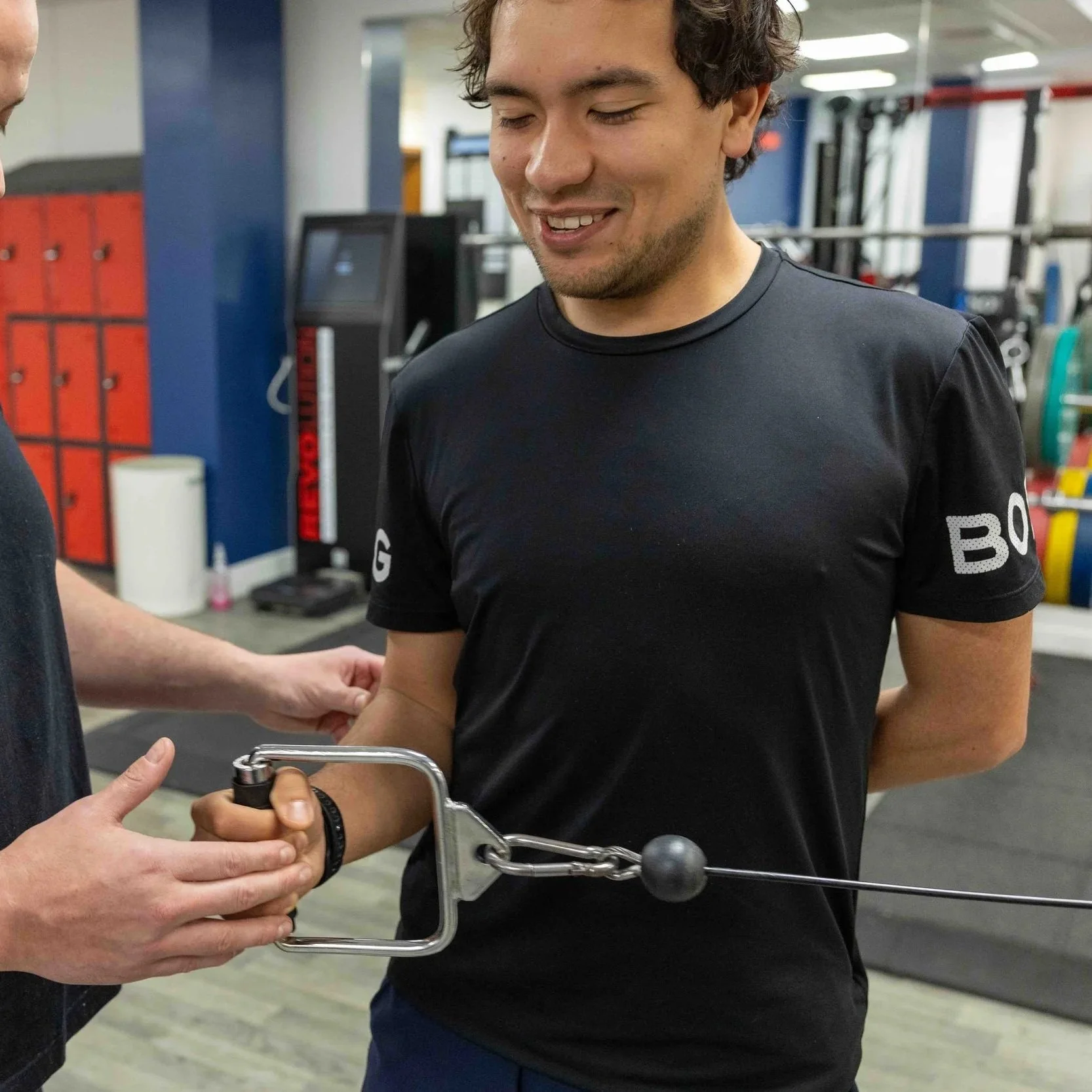 Client performing a cable resistance exercise during a personal training session at NRG Sports Therapy in Bloomsbury.