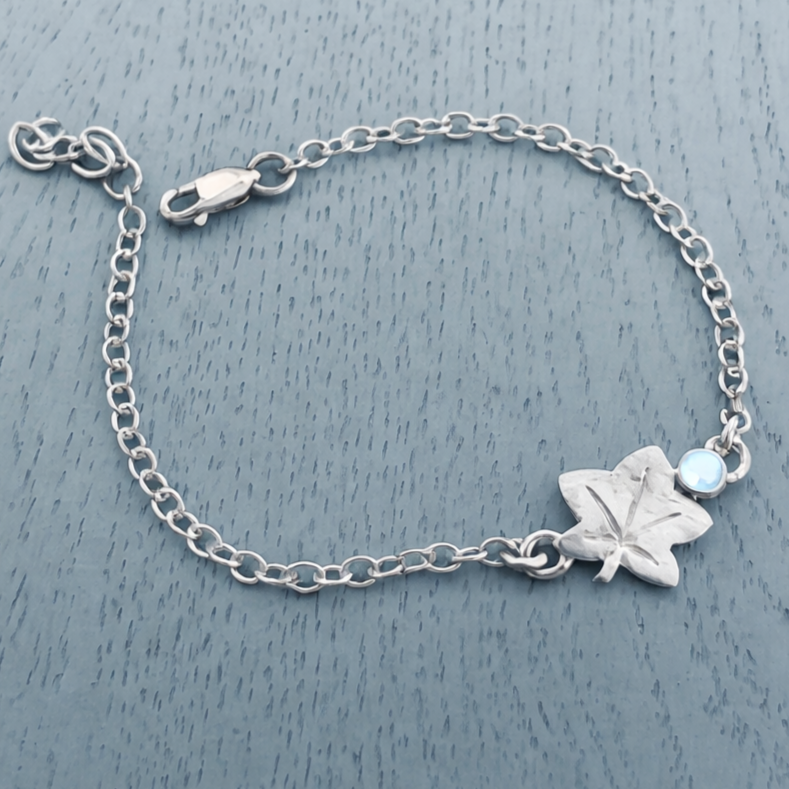 Silver+bracelet+with+moonstone+and+maple+leaf.png