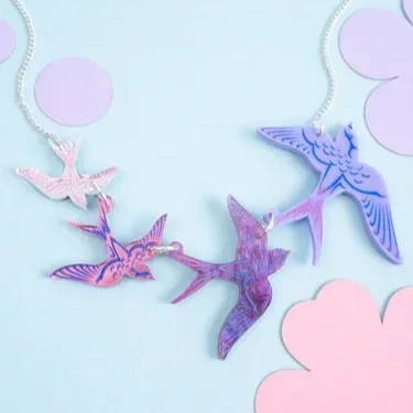 Swoop-of-Swallows-Necklace-Purple-Flatlay.webp