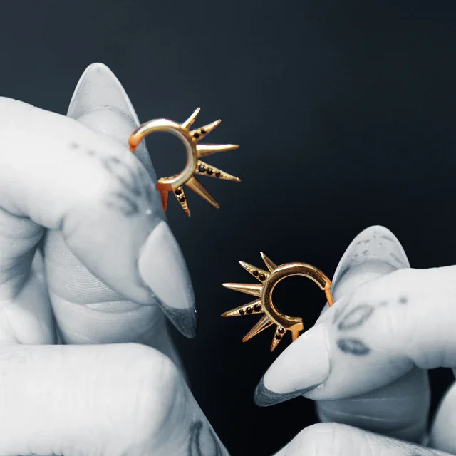 gold-black-spike-sun-hoop-earrings.webp