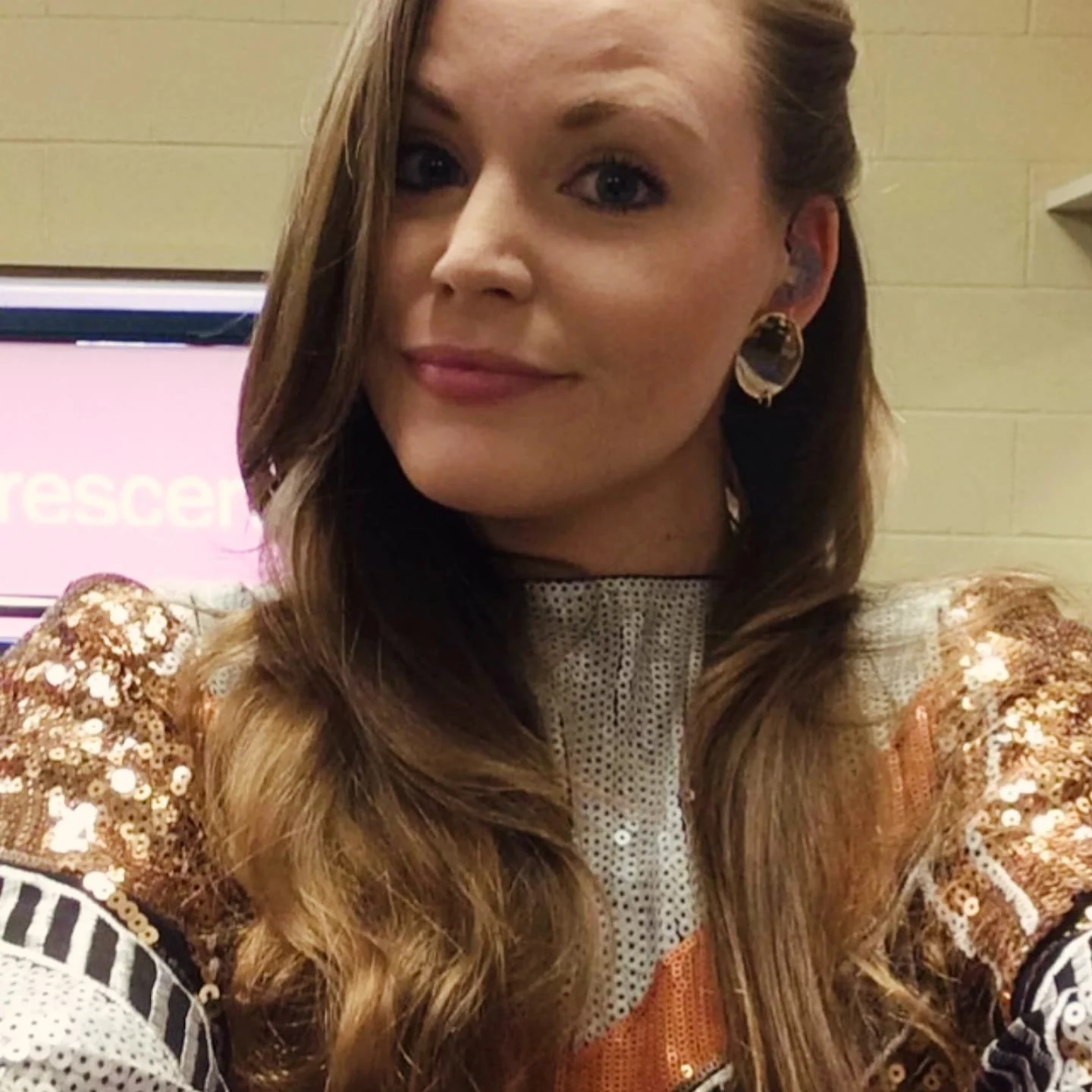 Kay from Sing with Kay smiling in a sparkly dress on the day of her singing promo video in Leicester